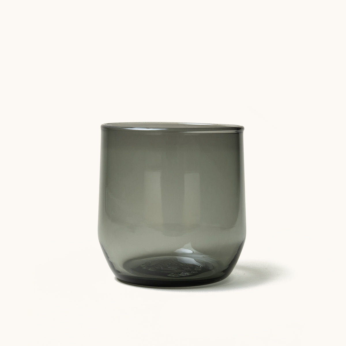 Dark grey translucent cocktail glass with a simple cylindrical shape.