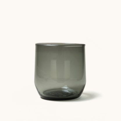 Dark grey translucent cocktail glass with a simple cylindrical shape.