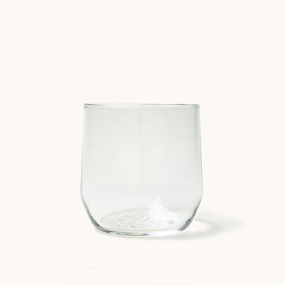 Clear, stemless cocktail glass with a gently curved silhouette, pictured on a white background.