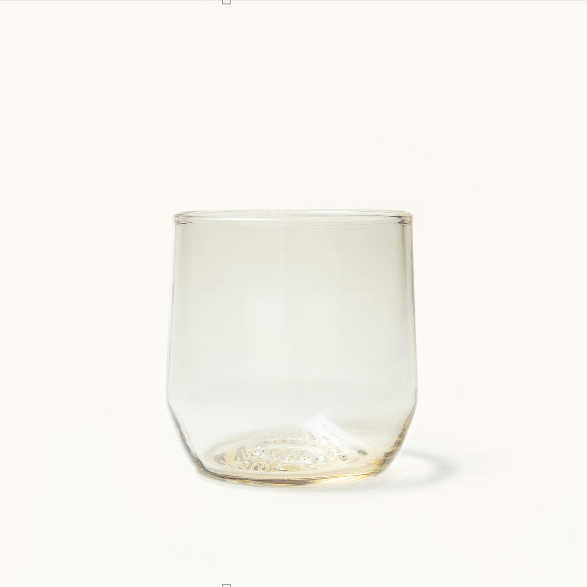 Light amber cocktail glass with a distinctive textured base.