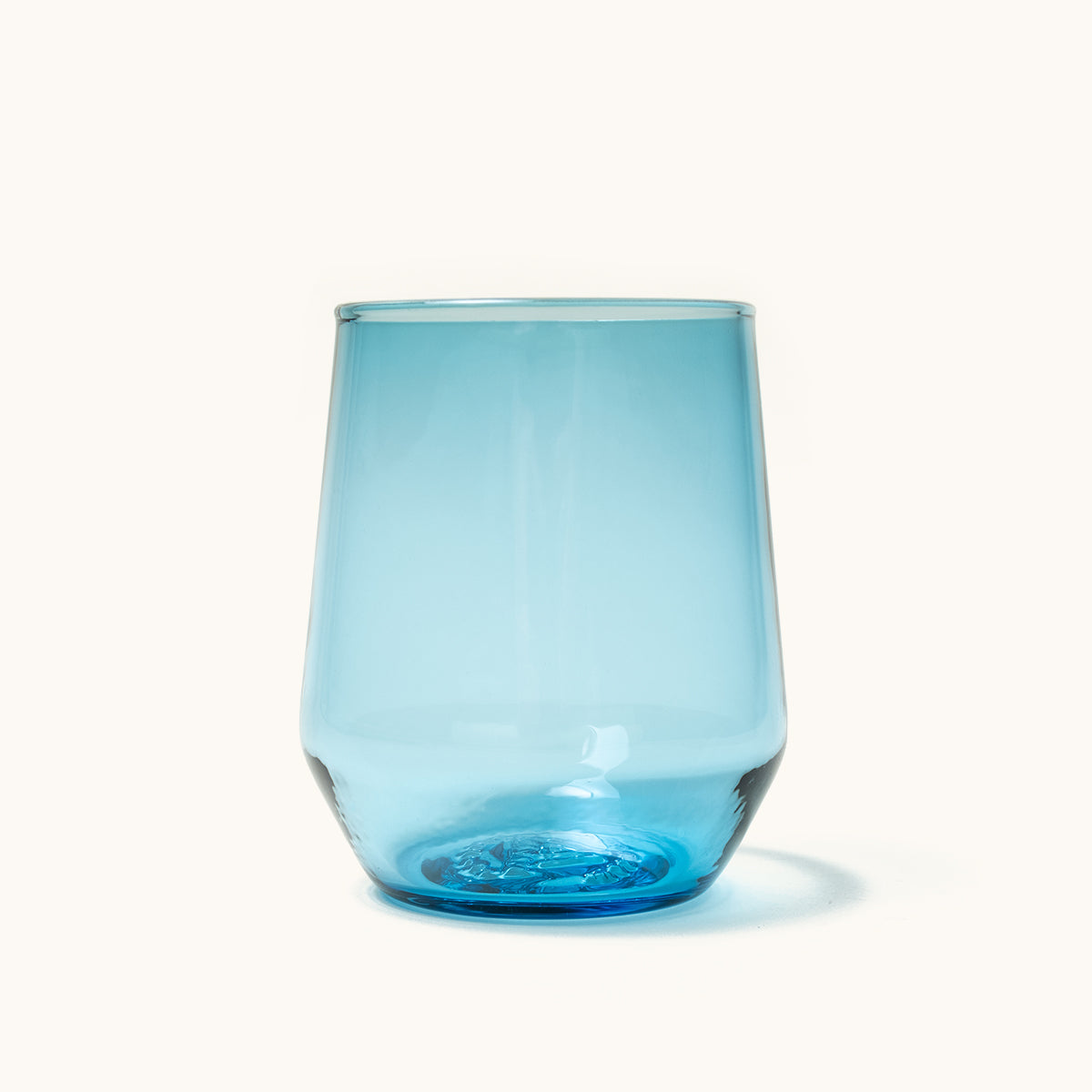 Light blue glass stemless wine glass, tapered with a clear rim and thick base.