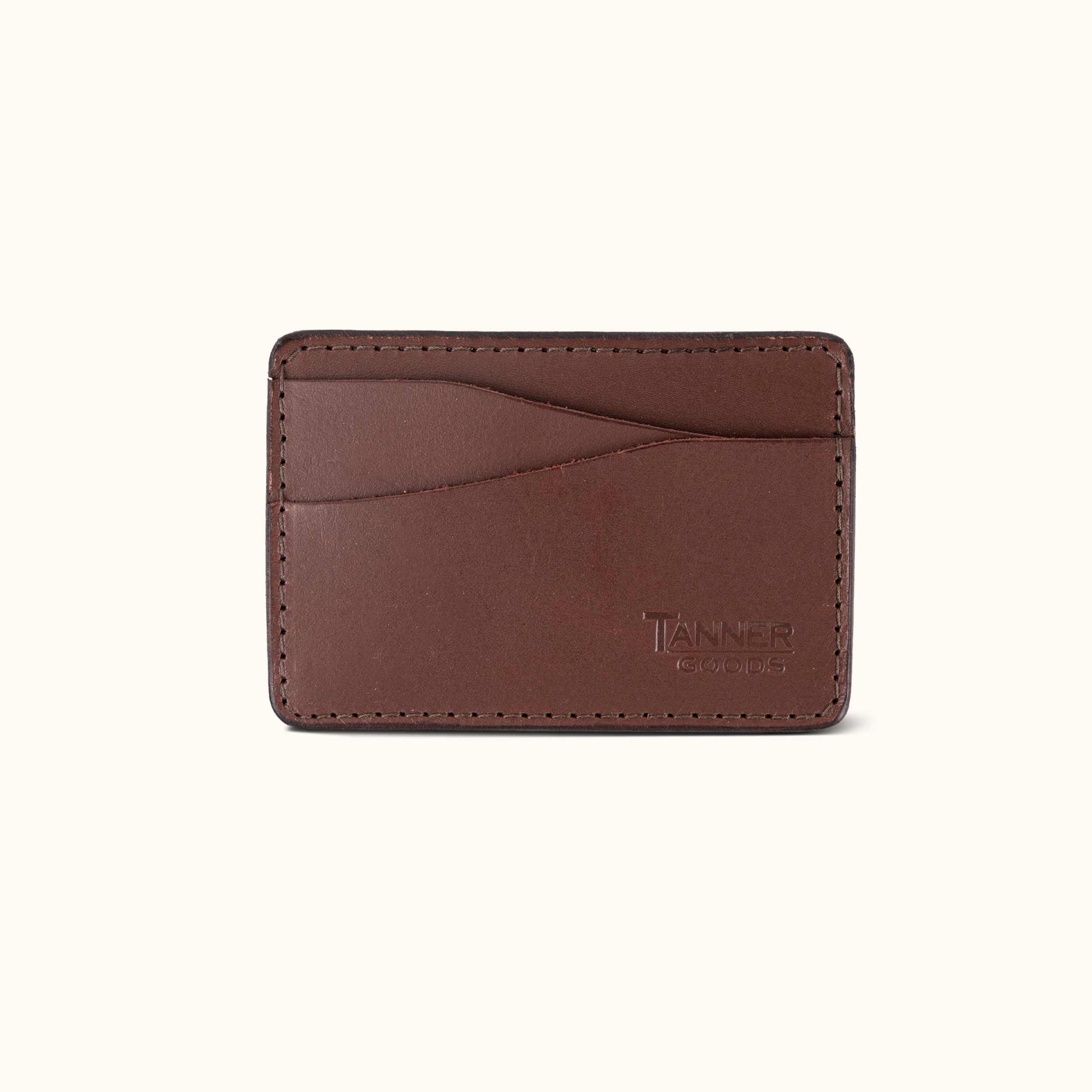Cognac leather money clip wallet by Tanner Goods with multiple card slots and stitched edges.