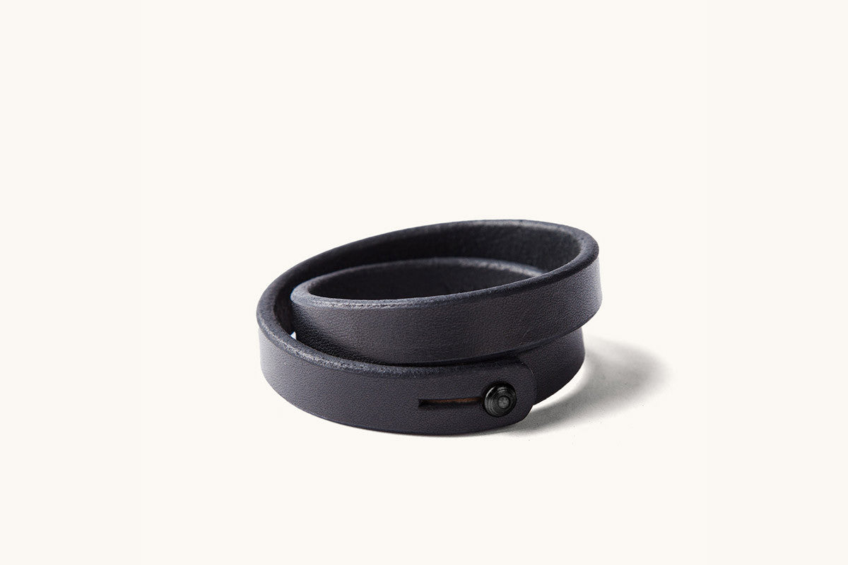 A double wrap black leather wristband with black metal closure.