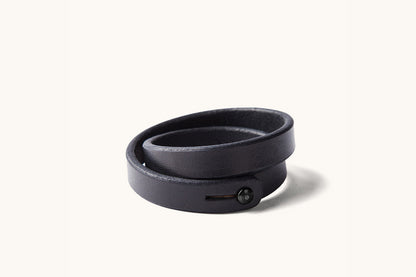 A double wrap black leather wristband with black metal closure.