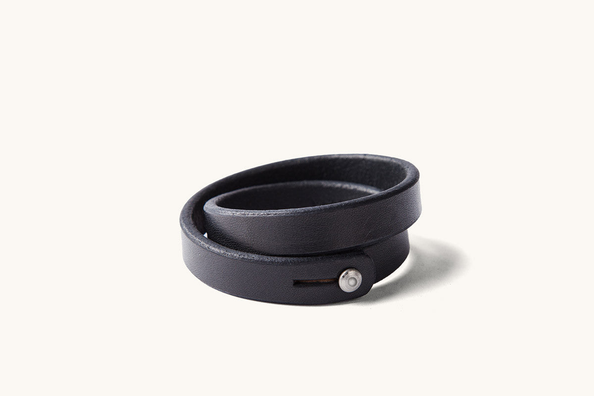A double wrap black leather wristband with metal closure.