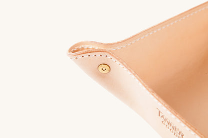 Natural leather valet tray by Tanner Goods, with white stitching and a brass rivet.