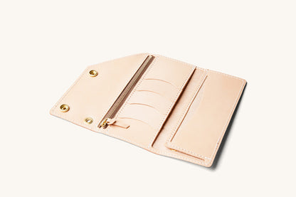 Natural Workman Wallet open and tilted, showing a zippered pocket, four card slots, and brass snap closures.